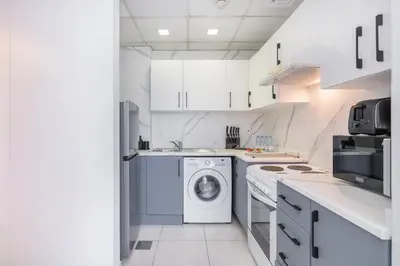 a white kitchen with a washing machine in it at HAVN - 2 Bedroom in Dubai Marina, 10min to Metro in Dubai