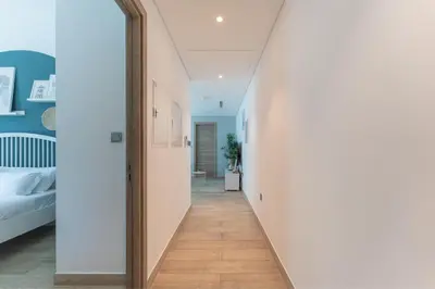 a hallway leading to a bedroom with a mirror at HAVN - 2 Bedroom Apartment with Dubai Marina View in Dubai