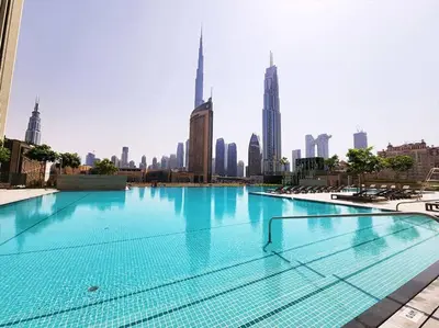 a large swimming pool in the middle of a city at RH- Luxury Living, Central 1-Bedroom near DIFC, High Floor, 8 mins walk to Dubai Mall in Dubai