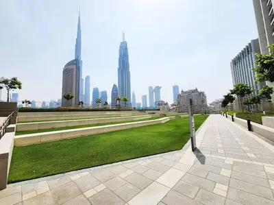 a park in a city with tall buildings at RH- Luxury Living, Central 1-Bedroom near DIFC, High Floor, 8 mins walk to Dubai Mall in Dubai