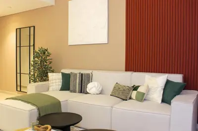 a living room with a white couch with pillows at RH- Luxury Living, Central 1-Bedroom near DIFC, High Floor, 8 mins walk to Dubai Mall in Dubai