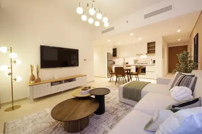 a living room with a couch and a tv at RH- Luxury Living, Central 1-Bedroom near DIFC, High Floor, 8 mins walk to Dubai Mall in Dubai
