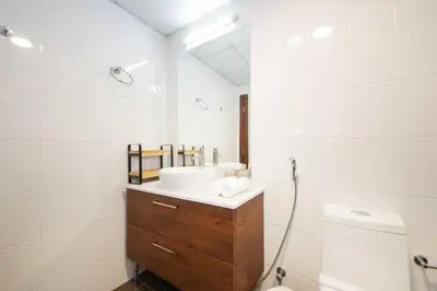 a white bathroom with a sink and a toilet at RH- High-Floor Splendor, 2-Bedroom Gem in Downtown in Dubai