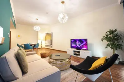a living room with a couch and a tv at RH- High-Floor Splendor, 2-Bedroom Gem in Downtown in Dubai