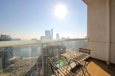 a balcony with a bench and a view of a city at RH- High-Floor Splendor, 2-Bedroom Gem in Downtown in Dubai
