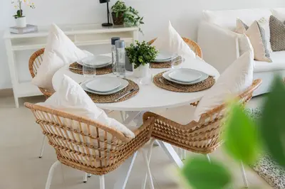 a white dining room table with chairs and pillows at Elite Escape Holiday Home - 2 BHK Getaway with Dubai Mall Access - 1508 in Dubai