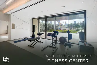 an office with a fitness center with chairs and windows at Elite Escape Holiday Home - 2 BHK Getaway with Dubai Mall Access - 1508 in Dubai
