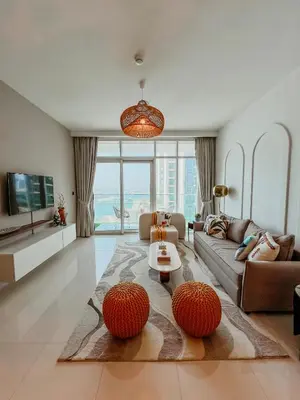 a living room with a couch and a table at Oceanfront Escape: Stylish 1 BR in Beachfront in Dubai