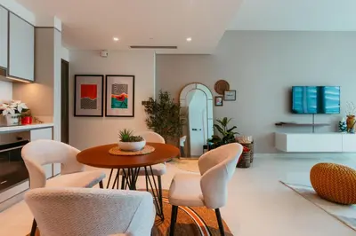 a dining room with a table and chairs at Oceanfront Escape: Stylish 1 BR in Beachfront in Dubai