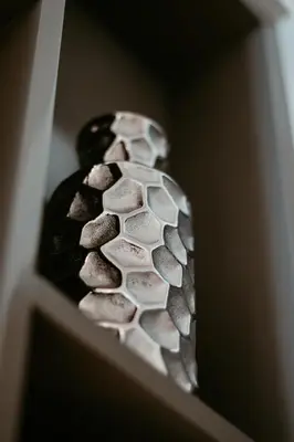 a vase filled with rocks sitting on a shelf at Oceanfront Escape: Stylish 1 BR in Beachfront in Dubai