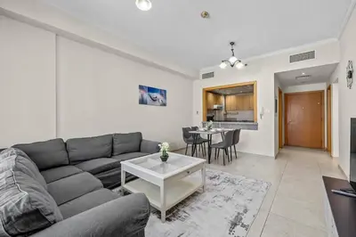 a living room with a couch and a table at Modern living nestled with 1BR_Silicon Oasis Dubai in Dubai