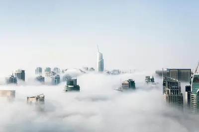 a foggy city with tall buildings in the background at Private Studio Burj Khalifa Area -BEST PRICE in Dubai