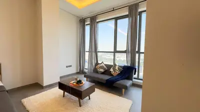 a living room with a couch and a large window at Private Studio Burj Khalifa Area -BEST PRICE in Dubai
