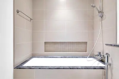 a bathroom with a shower with a tub at Luxurious Marina & Sea views 1BR near Blue Waters Dubai Marina By Maxx Value Homes in Dubai