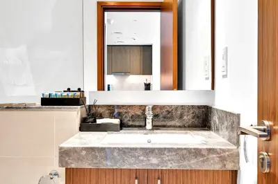 a bathroom with a sink and a mirror at Luxurious Marina & Sea views 1BR near Blue Waters Dubai Marina By Maxx Value Homes in Dubai
