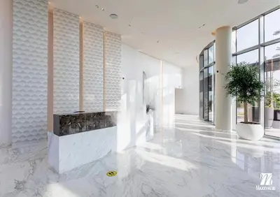 a lobby of a building with a plant on the floor at Luxurious Marina & Sea views 1BR near Blue Waters Dubai Marina By Maxx Value Homes in Dubai