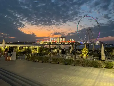 a view of a ferris wheel at night at 1 BR Flat, Luxury amenities, Near JBR Beach & Club with FREE Parking in JBR in Dubai