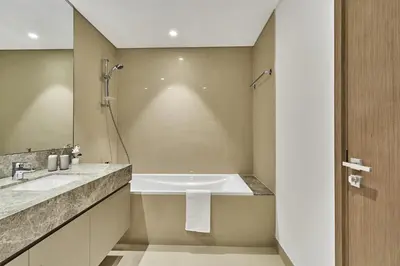 a bathroom with a tub and a sink at MAJESTIC Act Two 2BR- 27th Floor Burj Khalifa- Downtown Dubai in Dubai