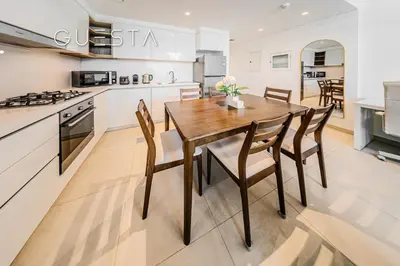 a kitchen and dining room with a wooden table and chairs at Downtown Views II by Emaar, Downtown Dubai in Dubai