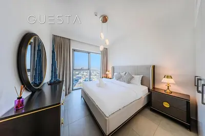 a bedroom with a bed and a large window at Downtown Views II by Emaar, Downtown Dubai in Dubai