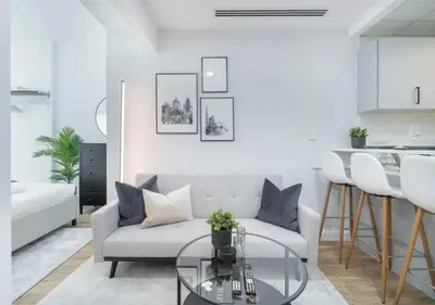 a living room with a couch and a table at HAVN - Studio Apartment in JLT, with Lake Views in Dubai