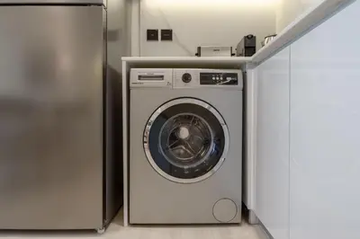 a washer and dryer in a small room at Luxury Living in 1 bedroom apartment in JVC in Dubai