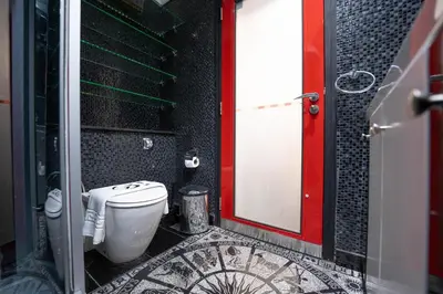 a bathroom with a toilet and a tile floor at 2 BR Marina View in Marina Heights By PK Holidays in Dubai