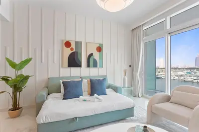 a living room with a bed and a couch at Luxury beach house with mesmerizing skyline view in Dubai