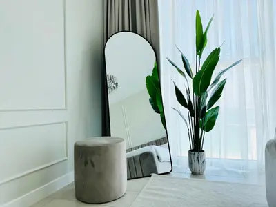 a bathroom with a stool and a mirror and a plant at Luxury Brand New 2 Bhk Apartment In La Vie -jbr in Dubai