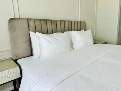 a large bed with white sheets and pillows at Luxury Brand New 2 Bhk Apartment In La Vie -jbr in Dubai