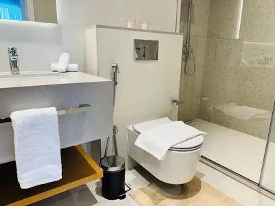 a bathroom with a toilet and a sink and a shower at Luxury Brand New 2 Bhk Apartment In La Vie -jbr in Dubai
