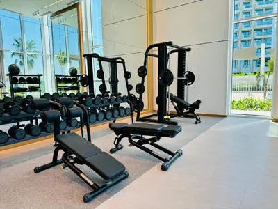 a gym with several tread machines in a room at Luxury Brand New 2 Bhk Apartment In La Vie -jbr in Dubai