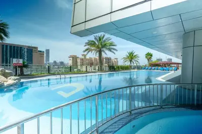 a large swimming pool on top of a building at Cozy Spacious Apartment 1BR in Dubai