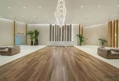 a living room with a wooden floor and two couches at Special Offer Stylish 1BR with Scenic Views & Pool by Deluxe Holiday Homes in Dubai