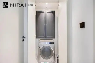 a bathroom with a toilet with a cabinet above it at Mira Holiday Homes-Marina Vista Emaar Beachfront in Dubai