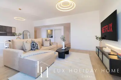 a living room with a couch and a table at LUX The Dubai Eye Sea View Suite in Dubai