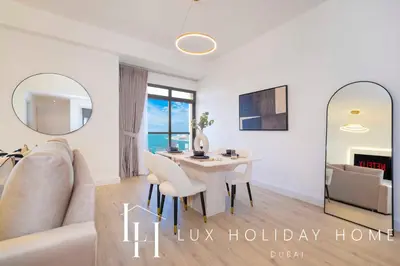 a living room with a table and a couch at LUX The Dubai Eye Sea View Suite in Dubai
