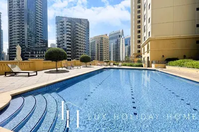 a large swimming pool in a city with tall buildings at LUX The Dubai Eye Sea View Suite in Dubai