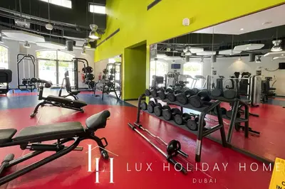 a gym with lots of treadmills and weights at LUX The Dubai Eye Sea View Suite in Dubai