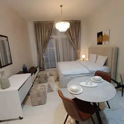 a hotel room with a bed and a table and chairs at Jwelz By Danube in Dubai