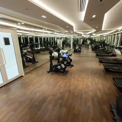a gym with rows of treadmills and elliptical machines at Jwelz By Danube in Dubai
