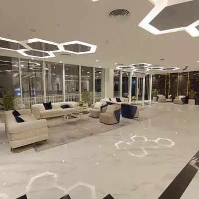 a lobby with couches and tables in a building at Jwelz By Danube in Dubai