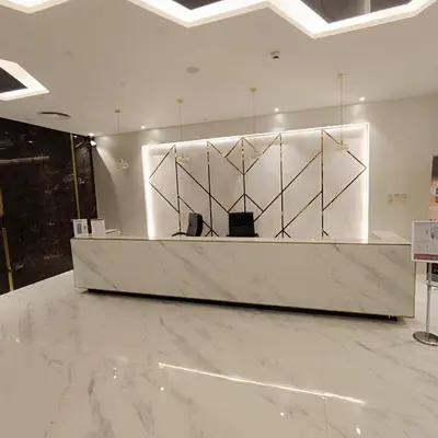 a lobby with a reception desk in a building at Jwelz By Danube in Dubai
