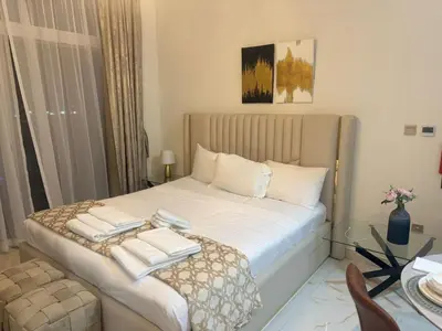 a bedroom with a bed with towels on it at Jwelz By Danube in Dubai