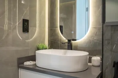 a bathroom with a white sink and a mirror at Astonishing 2 bedroom apt full Burj Khalifa view in Dubai