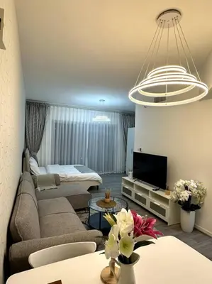 a living room with a couch and a tv at Dubai Marina - Huge Luxury Studio Apartment in Dubai
