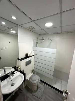 a bathroom with a sink and a toilet and a mirror at Dubai Marina - Huge Luxury Studio Apartment in Dubai