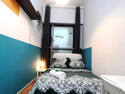 a bedroom with a bed with a teddy bear on it at Relaxing Closed Partition Room in Tecom Near Metro in Dubai