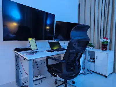 an office with a desk with a computer and a chair at LeModCasa: Smart, modern studio in JVC in Dubai