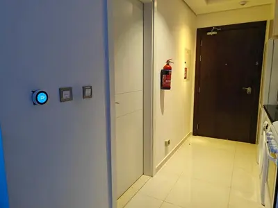 a hallway with a fire hydrantacistacistacistacistacist at LeModCasa: Smart, modern studio in JVC in Dubai